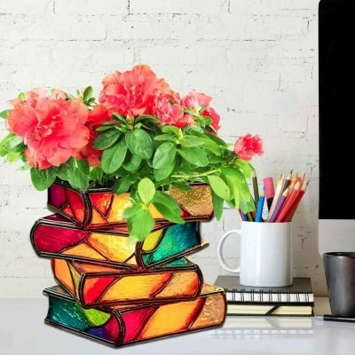 pot de fleur biblio quatre livres avec fleurs sur bureau